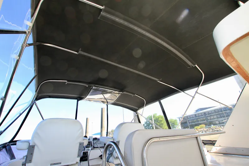 Slide: The Image of 1987 Ocean Alexander 42 yacht interior with seating and canopy, showcasing elegant design. - 24