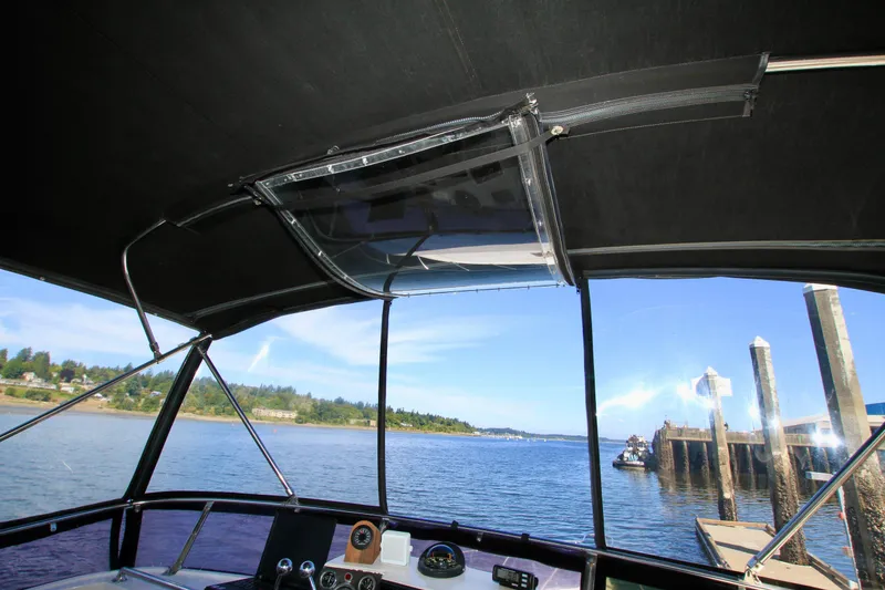 Slide: The Image of Interior view from 1987 Ocean Alexander 42 yacht, overlooking serene waterfront and dock. - 25