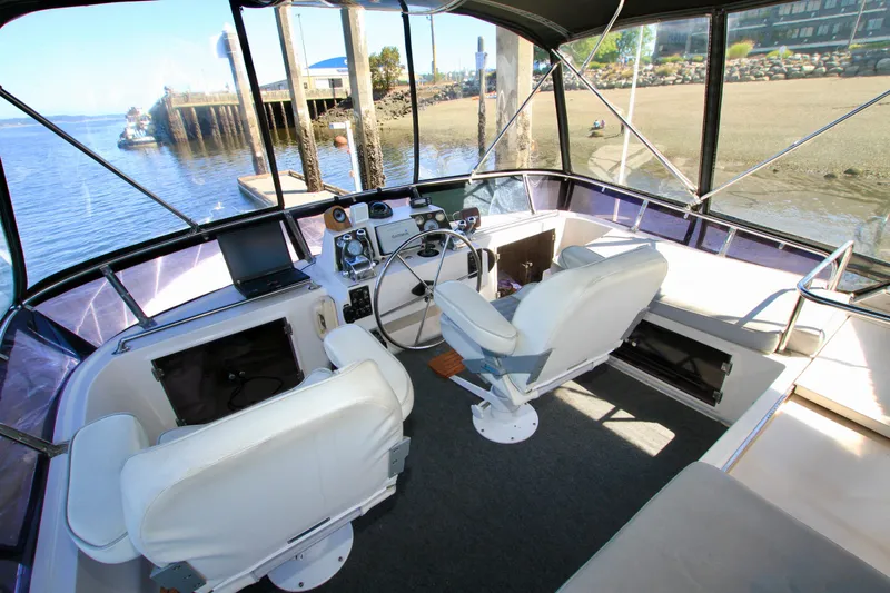 Slide: The Image of Cockpit of 1987 Ocean Alexander 42 yacht with dual seats and navigation equipment. - 26