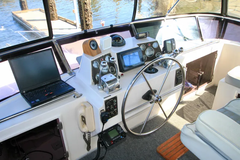 Slide: The Image of Cockpit of 1987 Ocean Alexander 42 yacht with steering wheel and navigation equipment. - 28