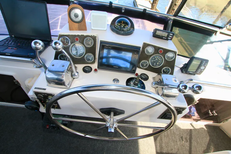 Slide: The Image of Cockpit of 1987 Ocean Alexander 42 yacht with steering wheel and navigation instruments. - 29