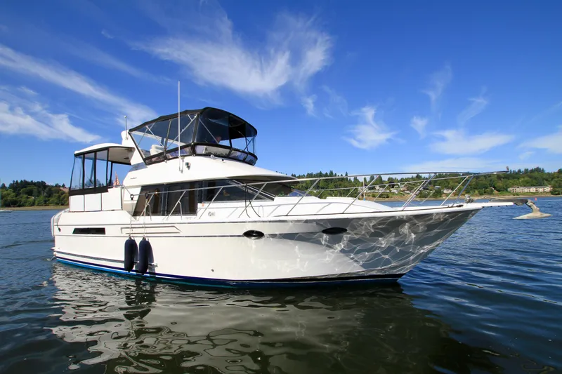 Slide: The Image of 1987 Ocean Alexander 42 yacht on calm water under clear blue sky. - 3