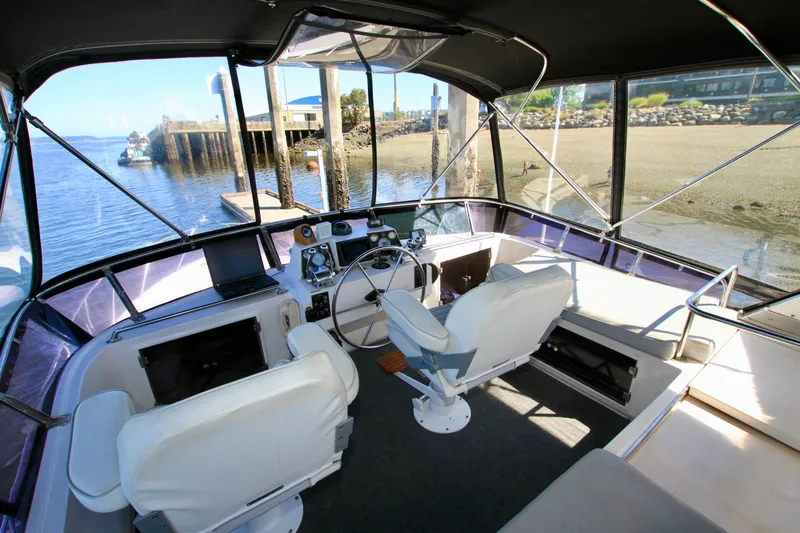 Slide: The Image of Interior view of 1987 Ocean Alexander 42 yacht cockpit with dual white captain chairs. - 30