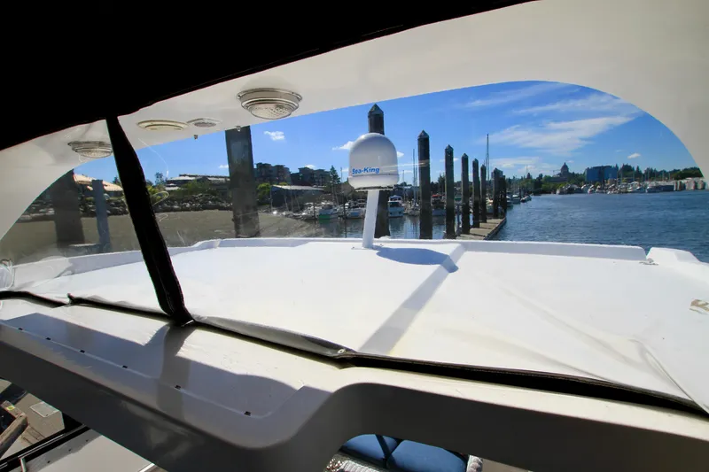Slide: The Image of 1987 Ocean Alexander 42 yacht view from cabin, overlooking marina and clear blue sky. - 31