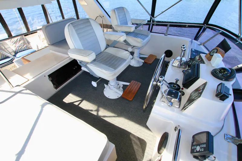 Slide: The Image of Interior helm of 1987 Ocean Alexander 42 yacht with dual captain chairs and navigation controls. - 33