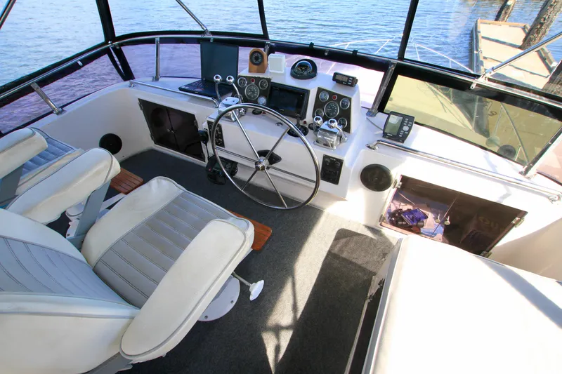 Slide: The Image of Cockpit of 1987 Ocean Alexander 42 yacht with steering wheel and navigation instruments. - 34