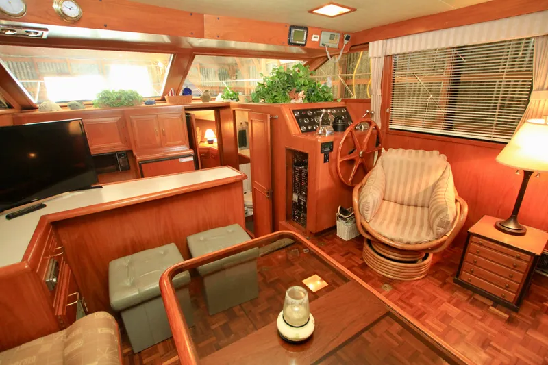 Slide: The Image of Luxurious 1987 Ocean Alexander 42 yacht interior with wood finish and cozy seating area. - 36
