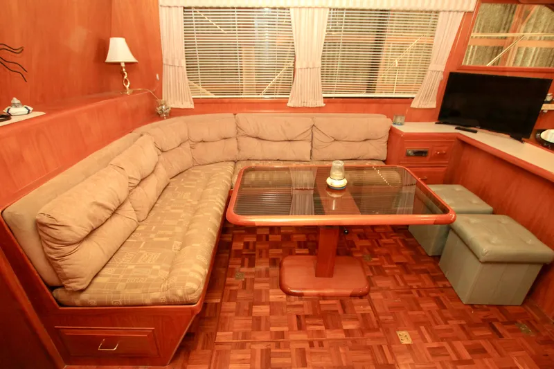 Slide: The Image of Interior of 1987 Ocean Alexander 42 yacht with cozy seating and wooden table. - 38