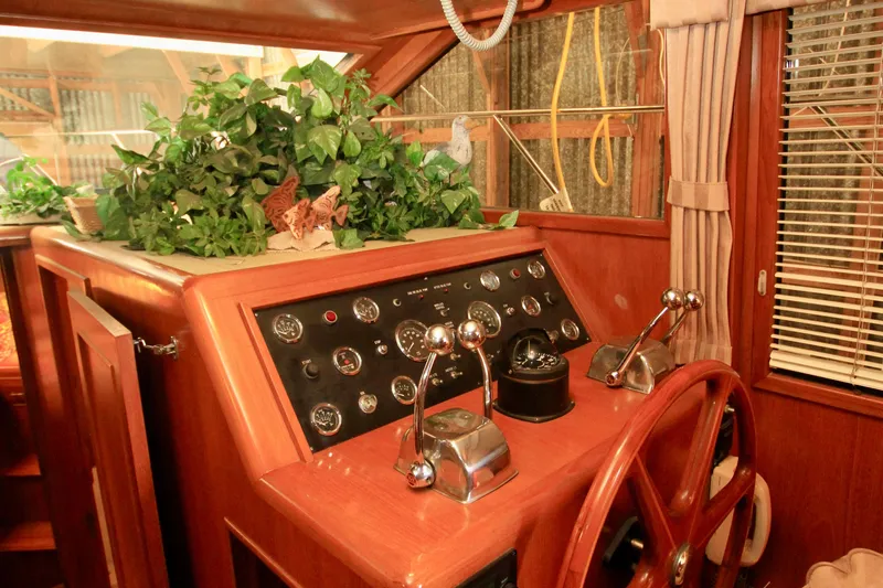 Slide: The Image of 1987 Ocean Alexander 42 yacht helm with wooden wheel and control panel. - 43