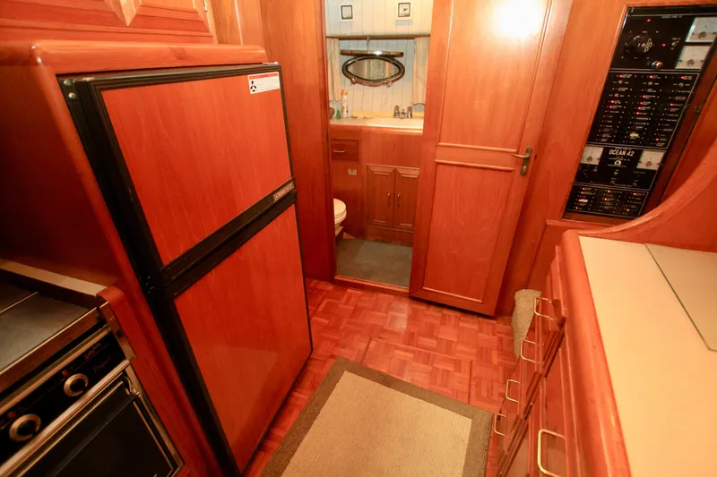 Slide: The Image of 1987 Ocean Alexander 42 yacht interior with wood cabinetry and modern appliances. - 48