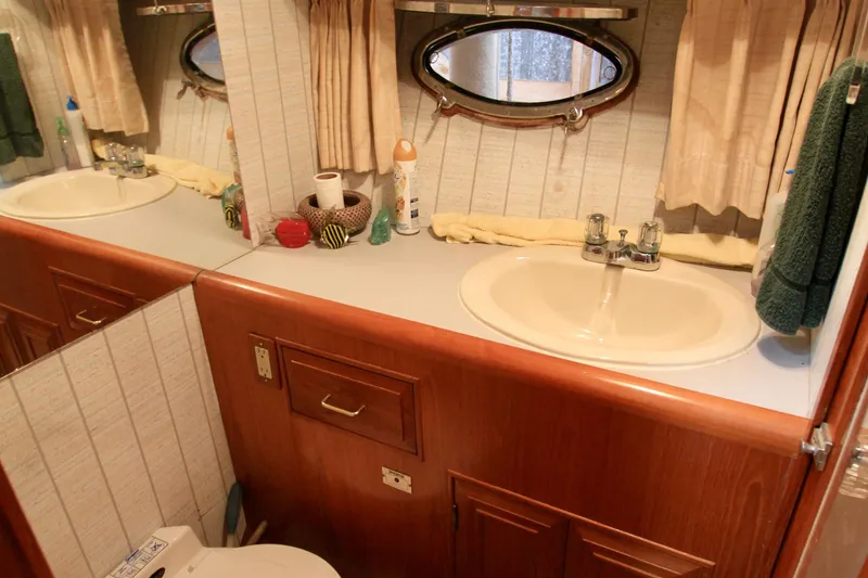 Slide: The Image of Bathroom interior of 1987 Ocean Alexander 42 yacht with sink and porthole window. - 50