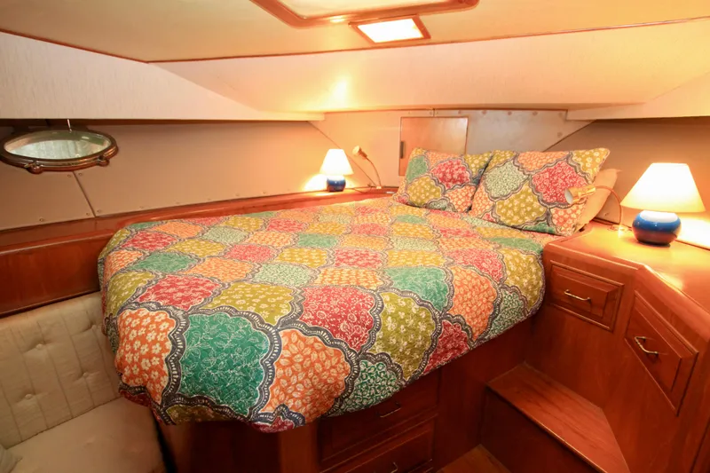 Slide: The Image of Cozy bedroom in 1987 Ocean Alexander 42 yacht with colorful bedding and warm lighting. - 52