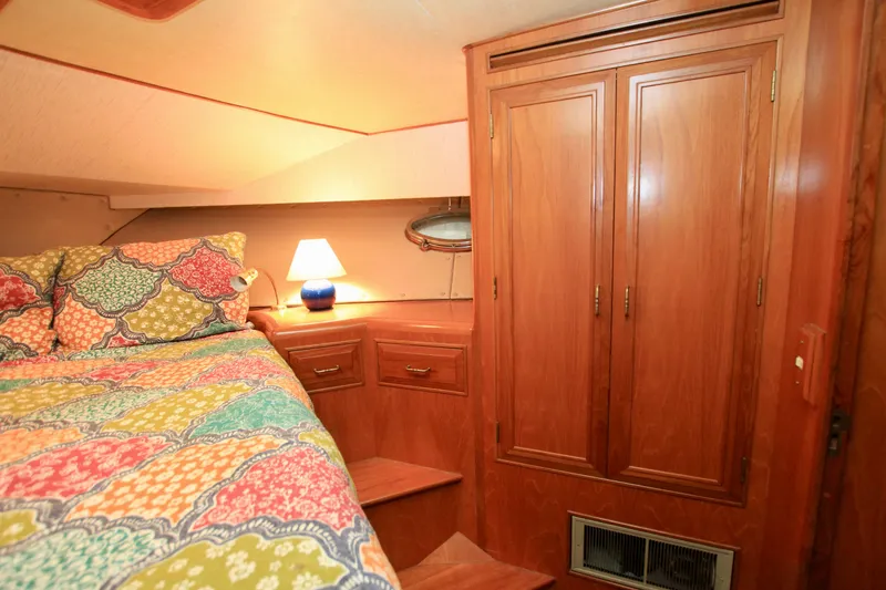 Slide: The Image of Cozy cabin interior of 1987 Ocean Alexander 42 with colorful bedding and wooden cabinetry. - 54