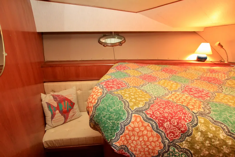 Slide: The Image of Cozy cabin interior of 1987 Ocean Alexander 42 with colorful bedding and nautical decor. - 55