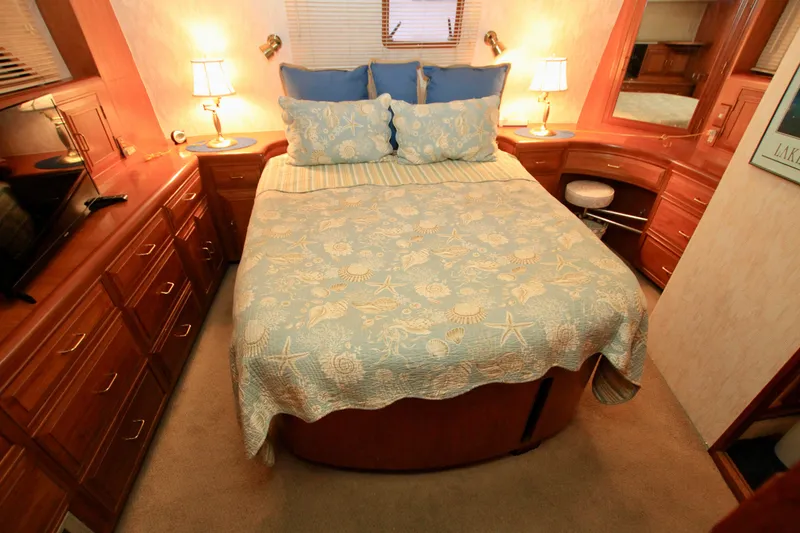 Slide: The Image of Luxurious bedroom interior of 1987 Ocean Alexander 42 yacht with elegant wood furnishings. - 57