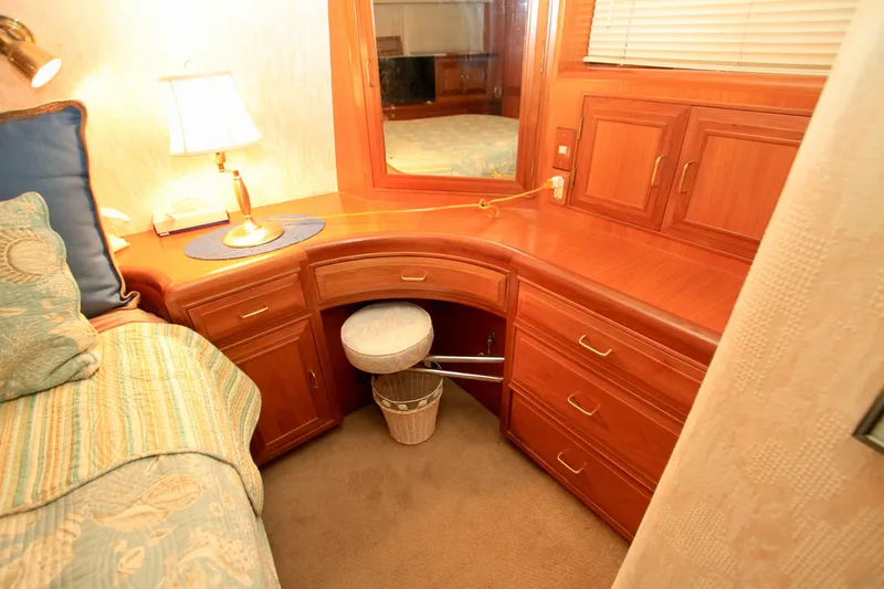 Slide: The Image of Luxurious 1987 Ocean Alexander 42 yacht interior with wooden cabinetry and cozy seating area. - 59