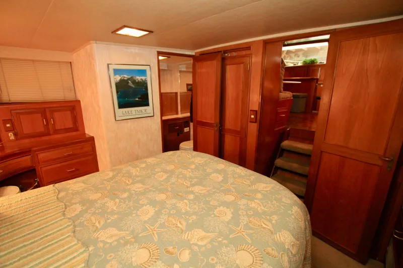 Slide: The Image of Cozy bedroom in 1987 Ocean Alexander 42 yacht with wood paneling and nautical decor. - 60