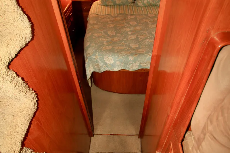 Slide: The Image of Cozy cabin interior of 1987 Ocean Alexander 42 yacht with wooden finish and patterned bedding. - 61