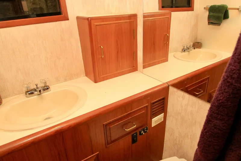 Slide: The Image of Bathroom vanity with dual sinks and wooden cabinetry on 1987 Ocean Alexander 42 yacht. - 62