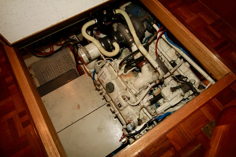 Slide: The Image of Engine room of 1987 Ocean Alexander 42 yacht, showcasing mechanical components and piping. - 66