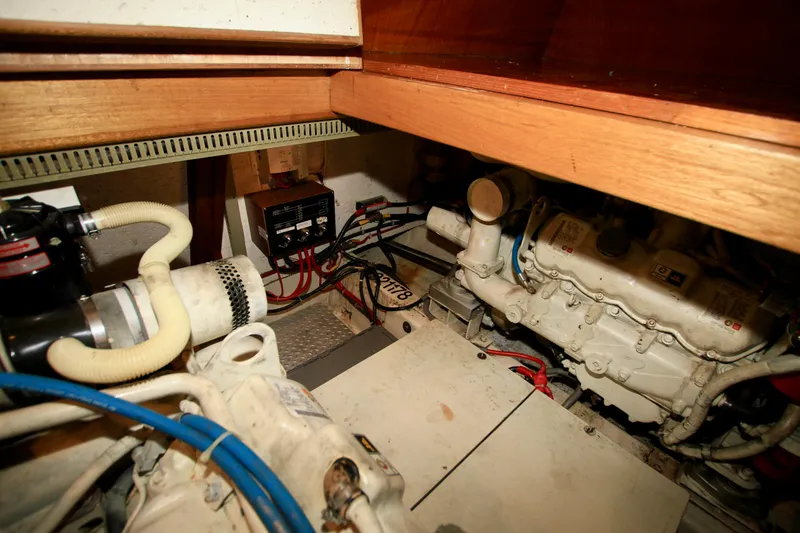Slide: The Image of Engine room of 1987 Ocean Alexander 42 yacht, showcasing mechanical components and wiring. - 67