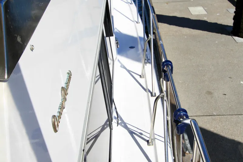 Slide: The Image of 1987 Ocean Alexander 42 yacht deck with stainless steel railings and dockside view. - 9