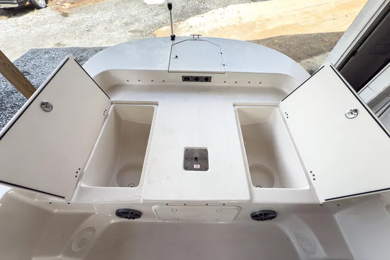 Slide: The Image of 2026 Carolina Skiff 23 LS boat seating with rod holders and storage. - 16