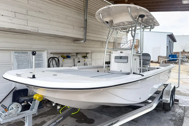 Slide: The Image of 2026 Carolina Skiff 23 LS boat interior with cushioned seating and storage compartments. - 21