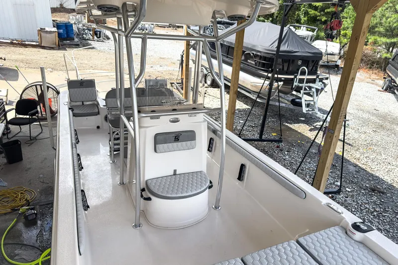 Slide: The Image of 2026 Carolina Skiff 23 LS boat in a workshop, showcasing spacious deck and modern design. - 3