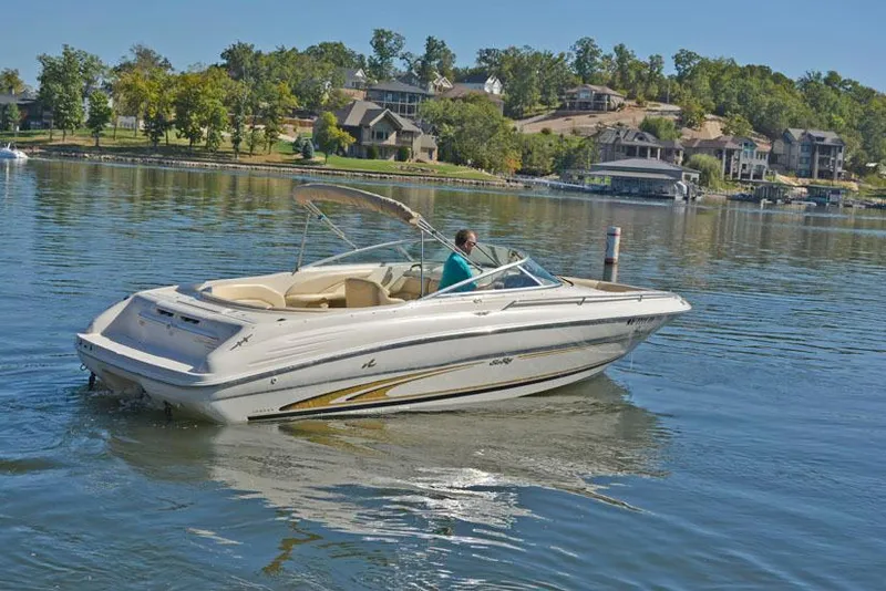 Slide: The Image of 2000 Sea Ray 260 Bow Rider on a calm lake with scenic background. - 10