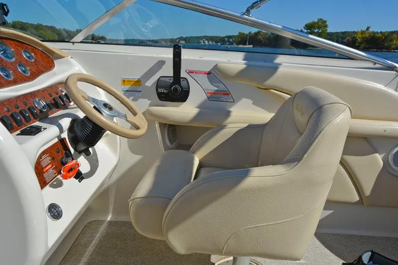 Slide: The Image of Interior of 2000 Sea Ray 260 Bow Rider boat with beige seating and control panel. - 13