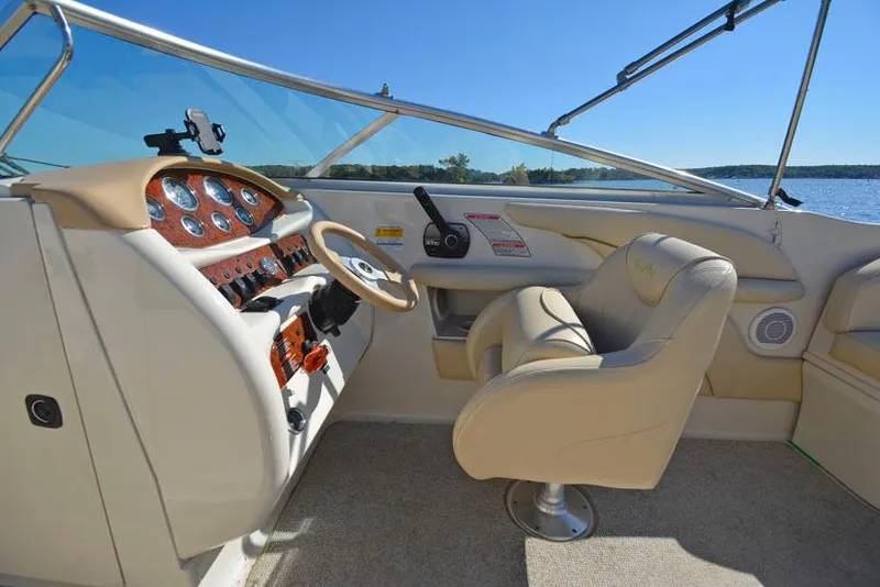 Slide: The Image of Interior of 2000 Sea Ray 260 Bow Rider boat with steering wheel and controls. - 14