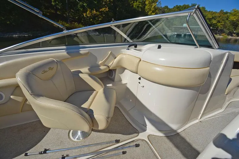 Slide: The Image of Interior of 2000 Sea Ray 260 Bow Rider with beige seating and steering console. - 15