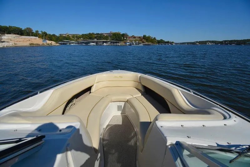 Slide: The Image of 2000 Sea Ray 260 Bow Rider on a scenic lake view. - 16