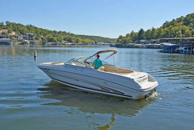 Slide: The Image of 2000 Sea Ray 260 Bow Rider cruising on a scenic lake. - 8