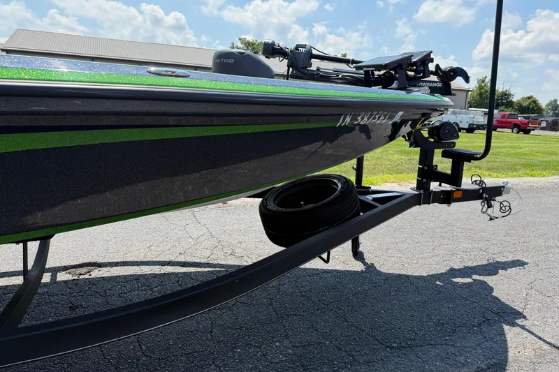 Slide: The Image of 2023 Nitro Z19 boat on trailer, parked on asphalt, under a partly cloudy sky. - 10