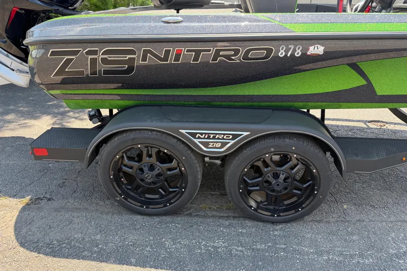 Slide: The Image of 2023 Nitro Z19 boat trailer with black wheels and green accents. - 11