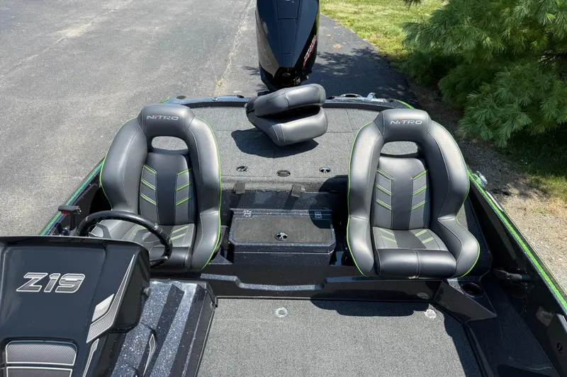 Slide: The Image of 2023 Nitro Z19 boat interior with two black and green seats. - 19