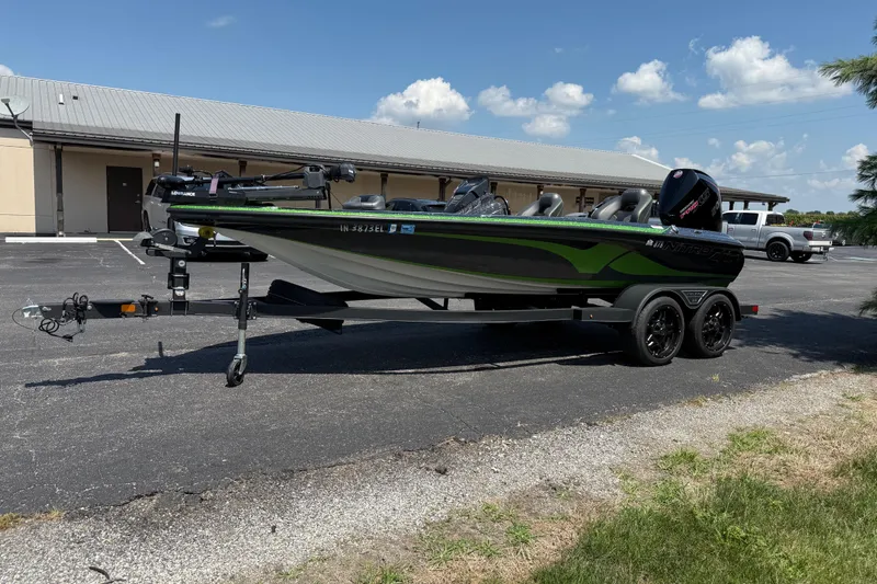 Slide: The Image of 2023 Nitro Z19 boat on trailer in parking lot under blue sky. - 3