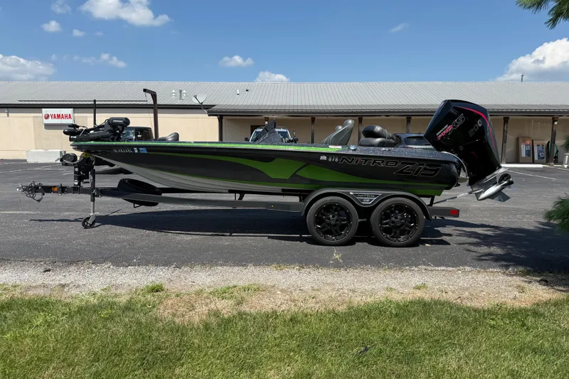 Slide: The Image of 2023 Nitro Z19 boat with trailer, parked outdoors near Yamaha building. - 6