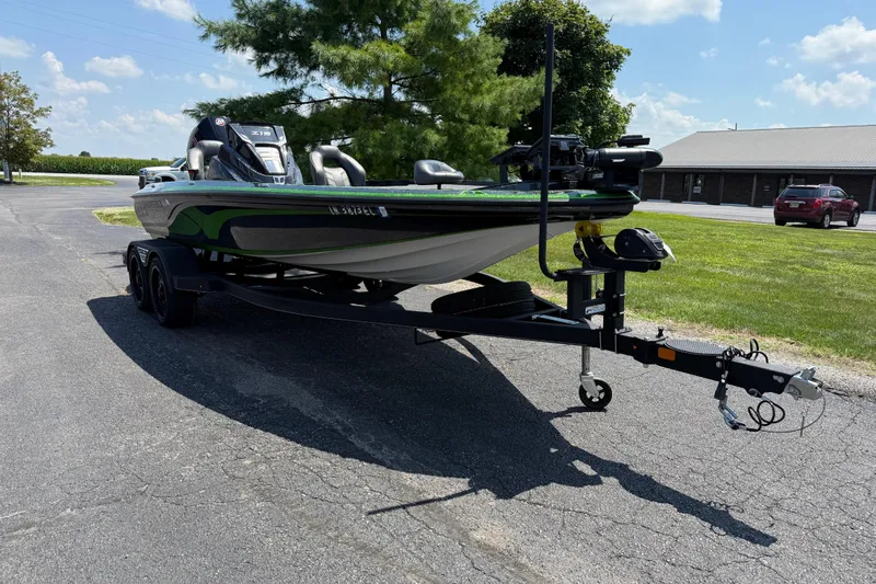 Slide: The Image of 2023 Nitro Z19 boat on trailer, parked outdoors under a clear sky. - 8