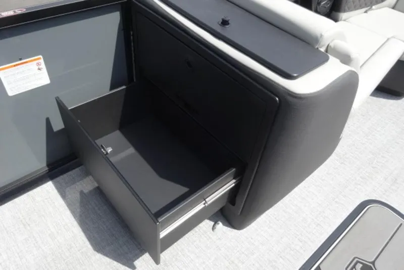 Slide: The Image of 2026 Harris Sunliner 250 boat interior with open storage drawer. - 12