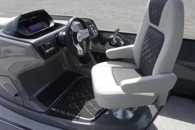 Slide: The Image of 2026 Harris Sunliner 250 boat helm with modern steering and comfortable captain's chair. - 14