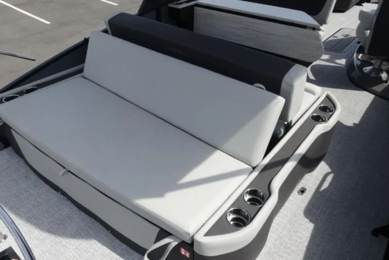 Slide: The Image of 2026 Harris Sunliner 250 boat seating area with cup holders and modern design. - 16