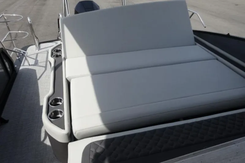 Slide: The Image of 2026 Harris Sunliner 250 boat with spacious seating and built-in cup holders. - 17