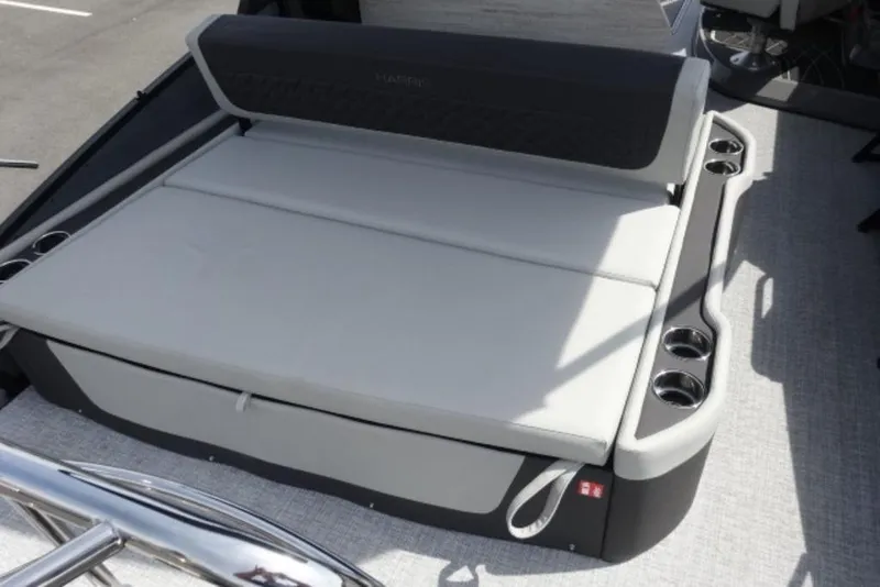Slide: The Image of 2026 Harris Sunliner 250 boat interior with cushioned seating and cup holders. - 18