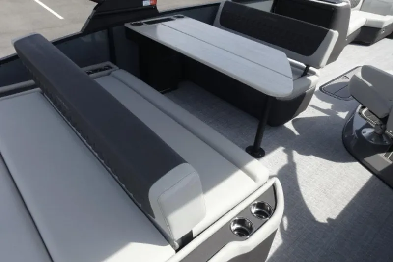 Slide: The Image of 2026 Harris Sunliner 250 boat interior with sleek seating and modern table design. - 20