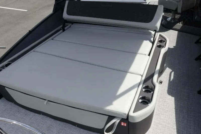 Slide: The Image of 2026 Harris Sunliner 250 boat with spacious sunbed and integrated cup holders. - 21