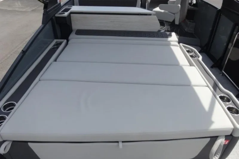 Slide: The Image of 2026 Harris Sunliner 250 boat interior with spacious cushioned seating and cup holders. - 22