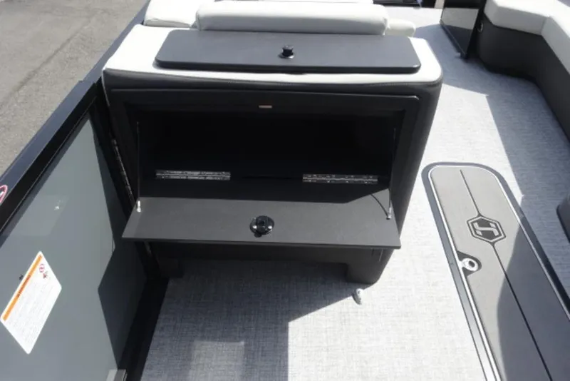 Slide: The Image of 2026 Harris Sunliner 250 boat interior with storage compartment and seating area. - 9